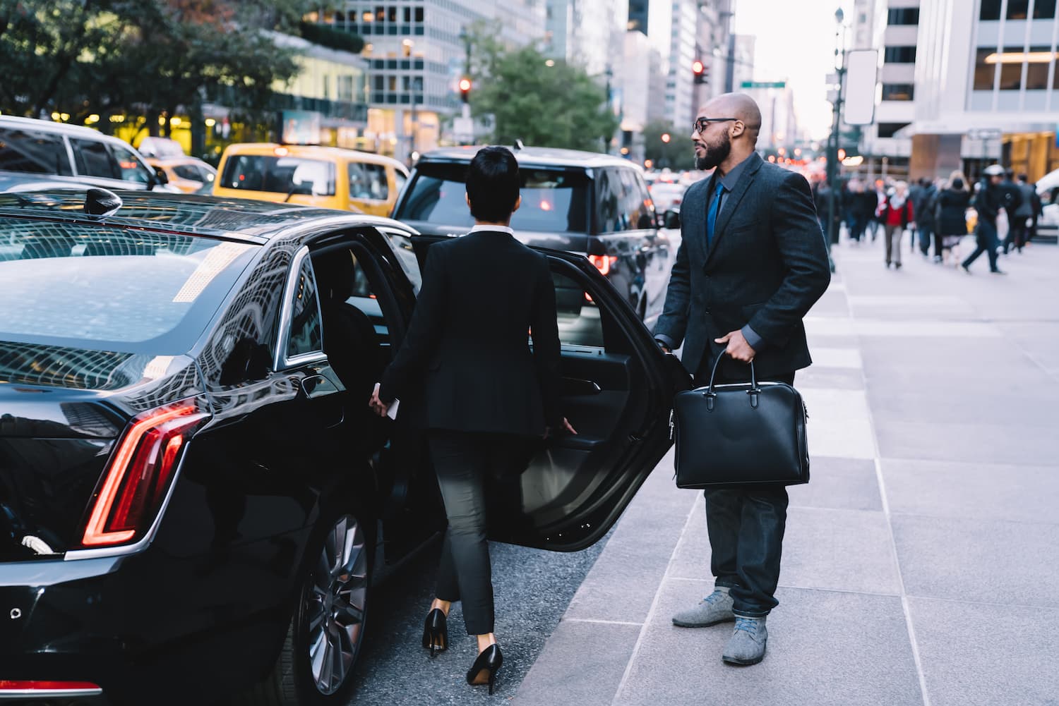 successful-business-partners-getting-in-car-at-cit-